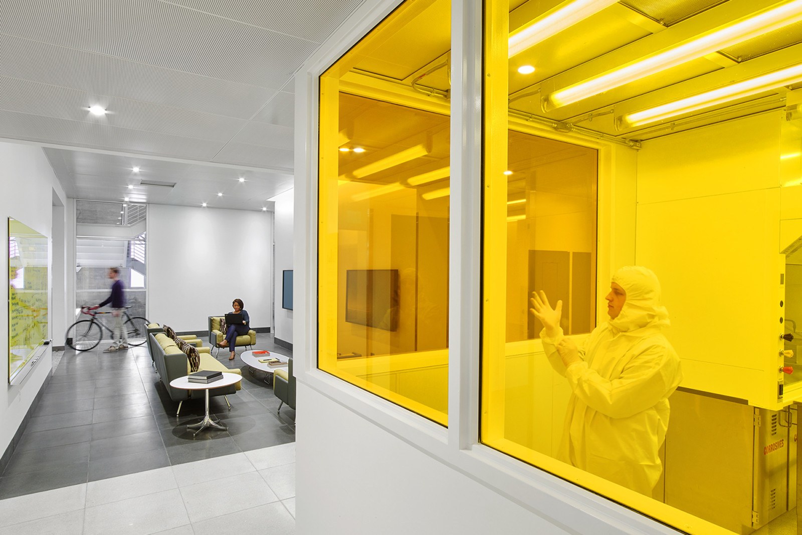 Image of a cleanroom with yellowlighting and a collaborative seating area at the University of Southern California's Michelson Hall