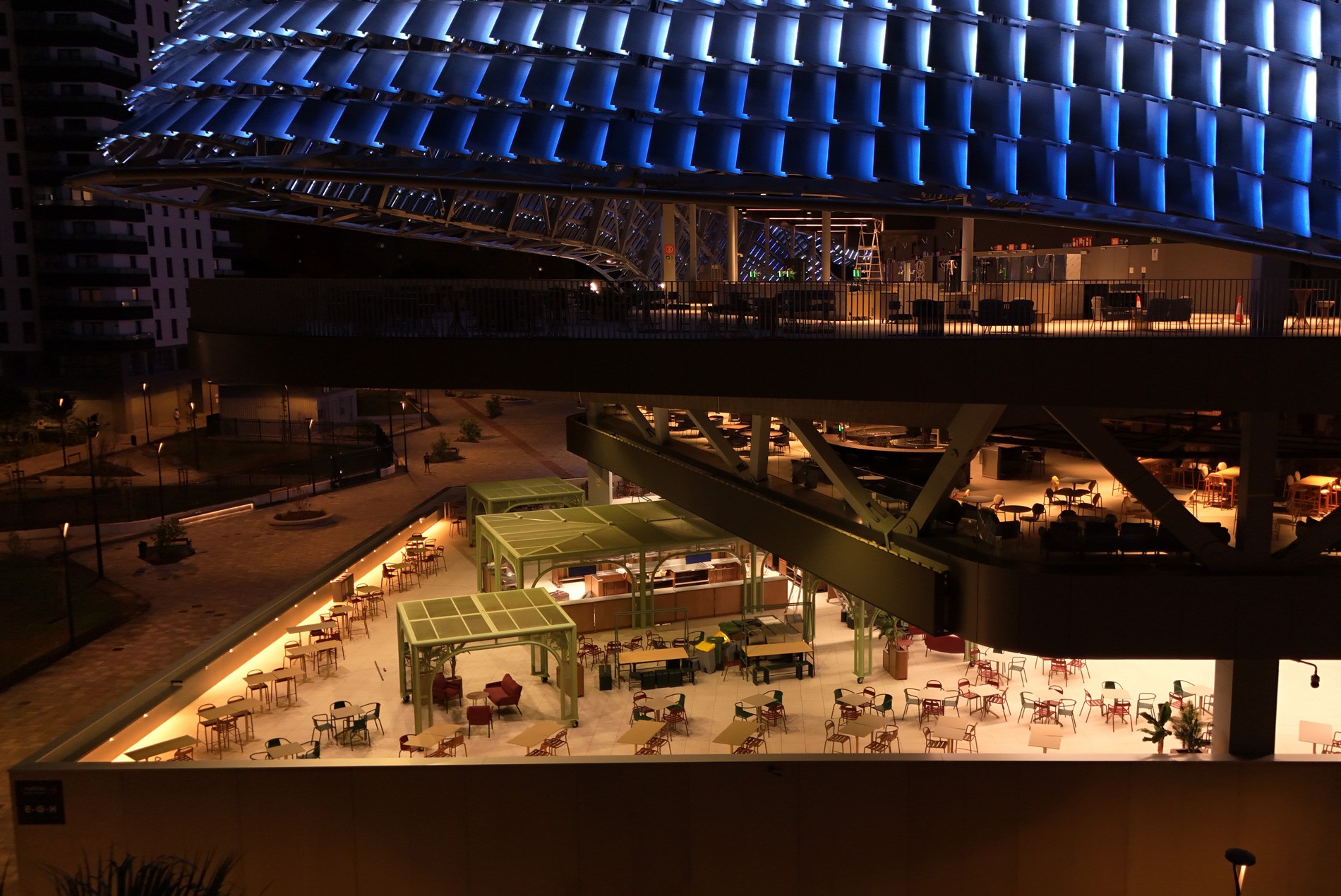 Outdoor lounge seating inside the Roig Arena at night