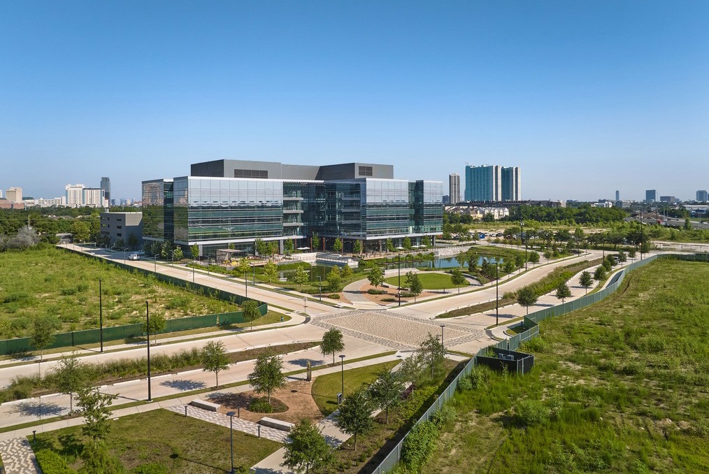 A pond and outdoor pathways and gathering spaces in front of the Hines' Levit Green life sciences hub.