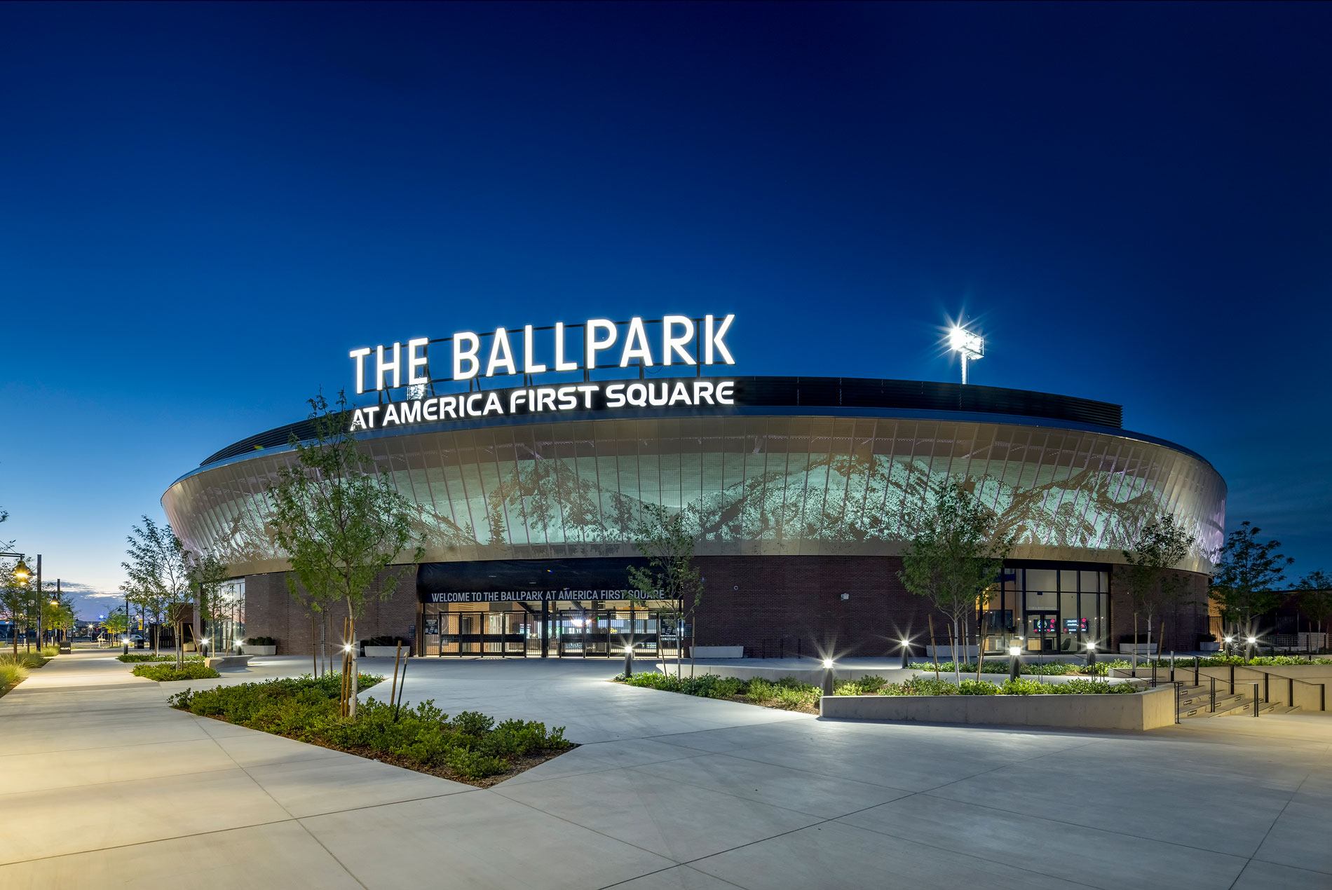 Exterior night shot of landscaping and the entrance to The Ballpark at America First Square, home of the Minor League Baseball's Salt Lake Bees.