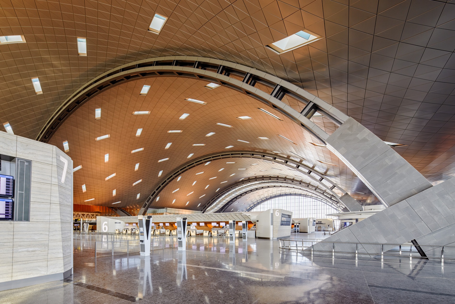 Check-in hall and curved ceiling with windows for natural light in HOK-designed Hamad International Airport in Qatar