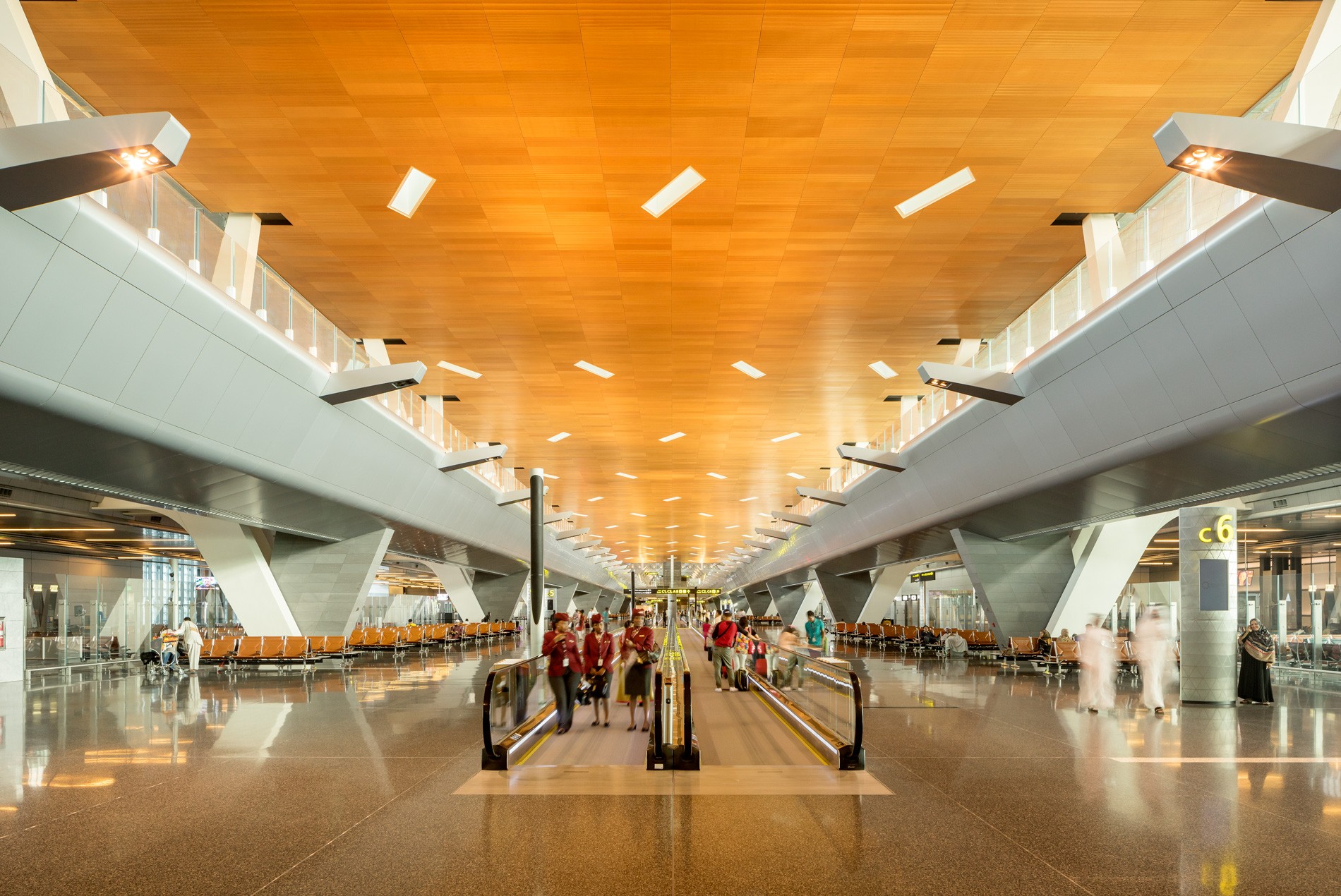 Warm wood ceiling and skylights within the concourse at HOK-designed Hamad International Airport in Qatar