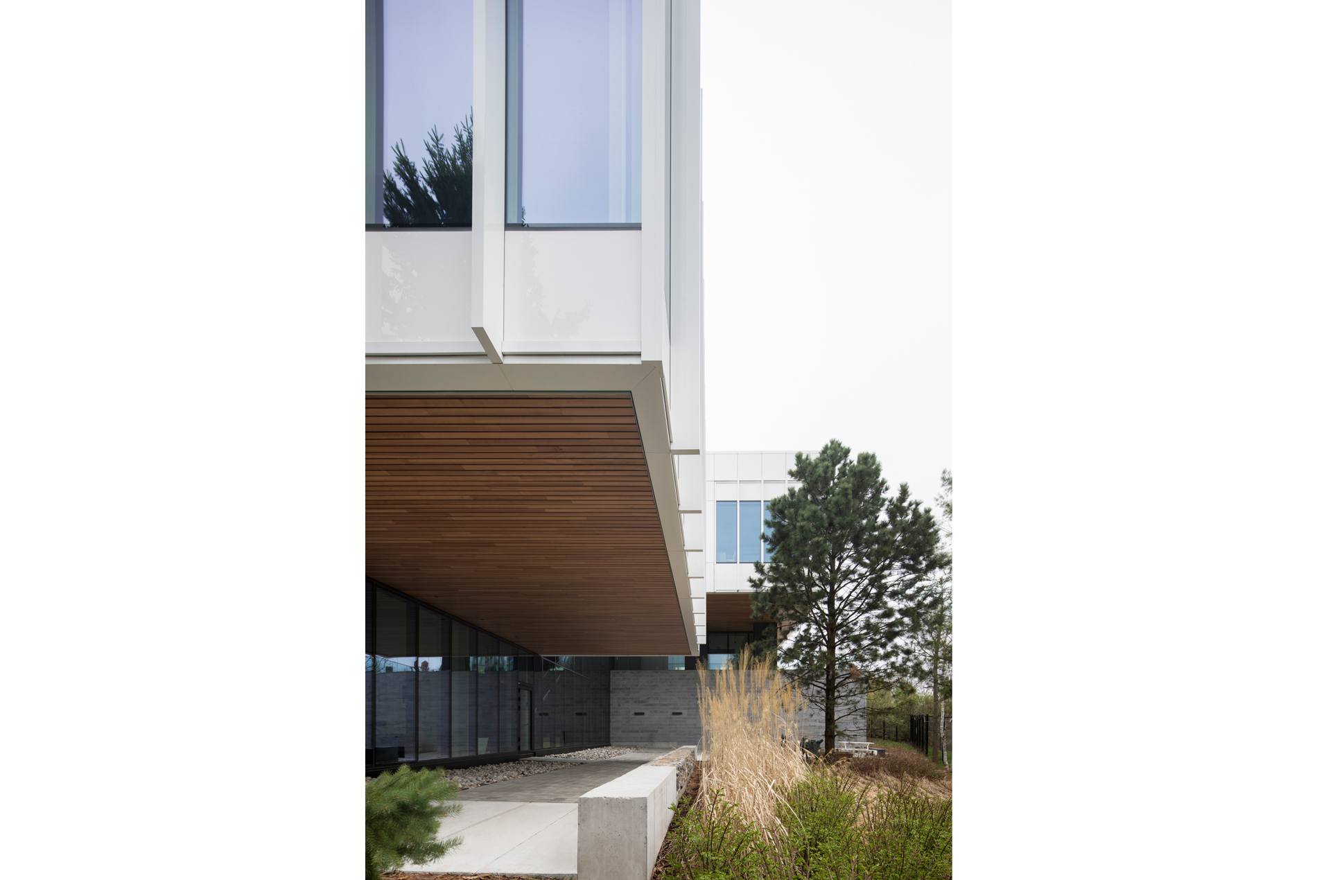 HOK-designed British High Commission exterior with a building overhang serving as a canopy under the pedestrian pathway.
