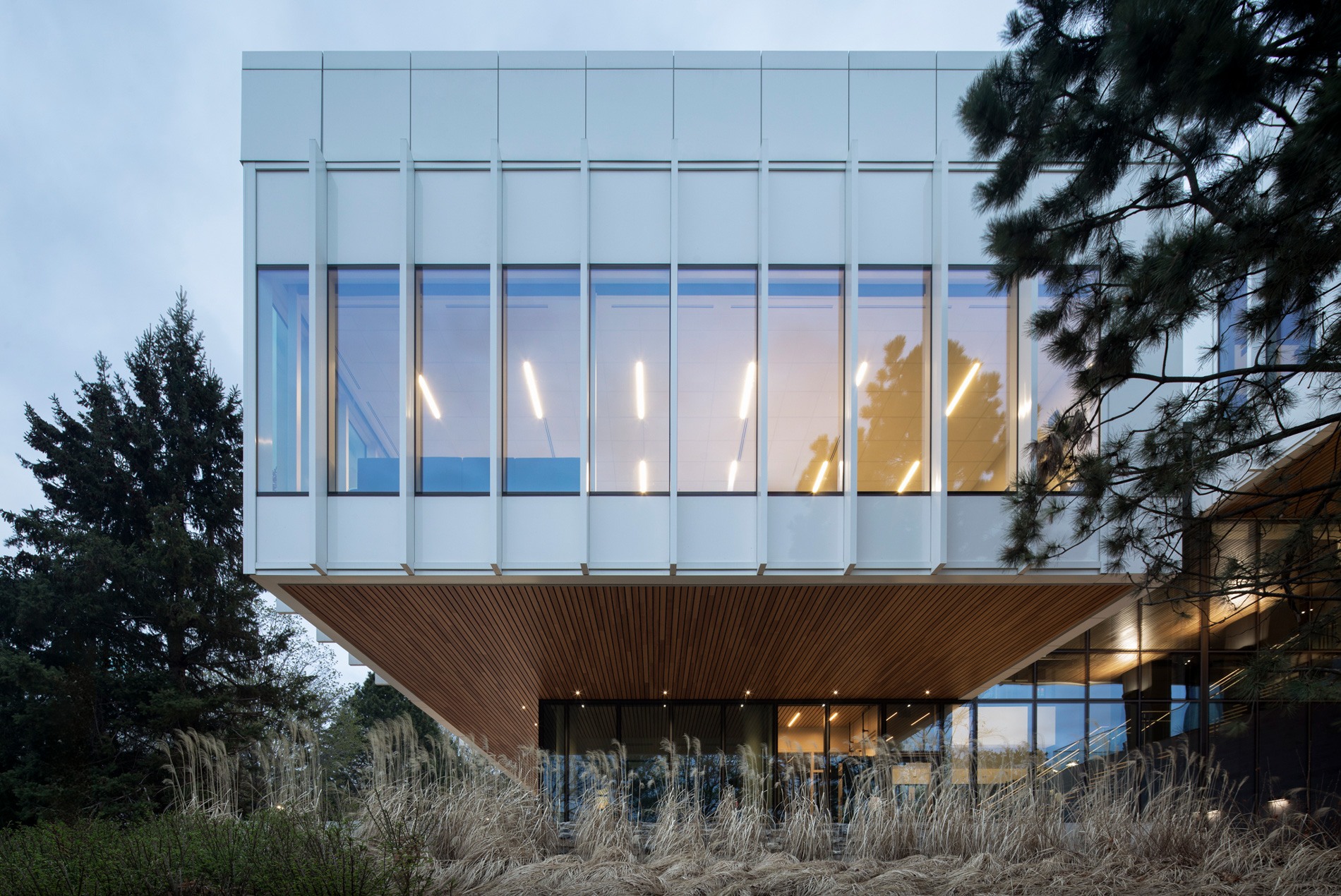 HOK-designed British High Commission exterior at dusk, showing full-length windows and vertical fins to reduce solar heat gain.