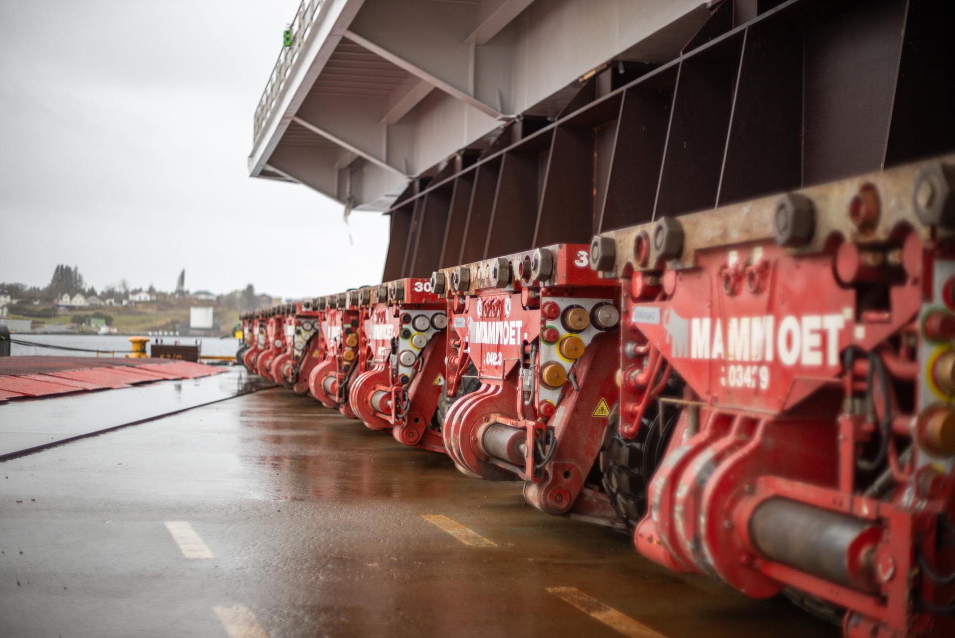 Mammoet transporters moving the Dogger Wind Bank megastructure during rainy weather.