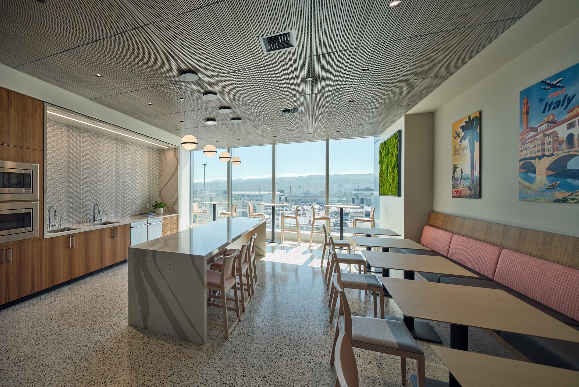 Kitchen space with daylight coming through the full windows at the HOK-designed executive offices at San Francisco International Airport