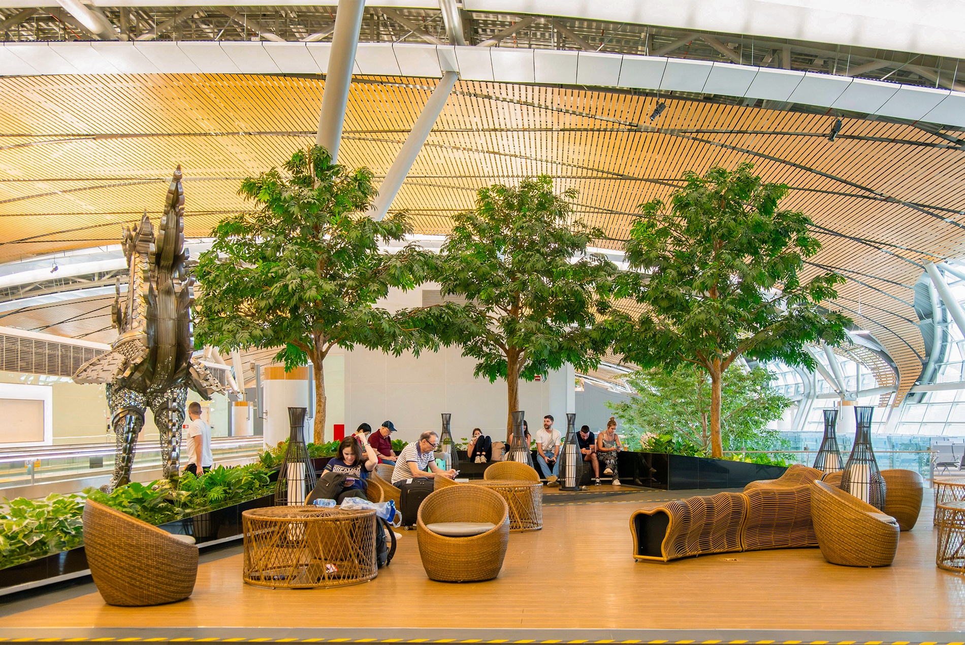 Suvarnabhumi Airport Midfield Satellite Concourse pocket greenery and lounge seating, designed by HOK