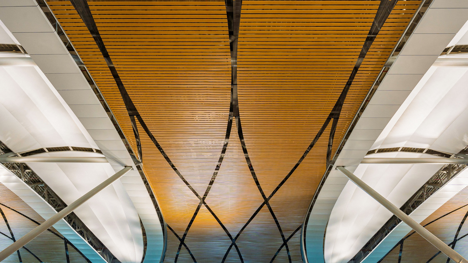 Wood-paneled curved ceiling at the Suvarnabhumi Airport Midfield Satellite Concourse, designed by HOK