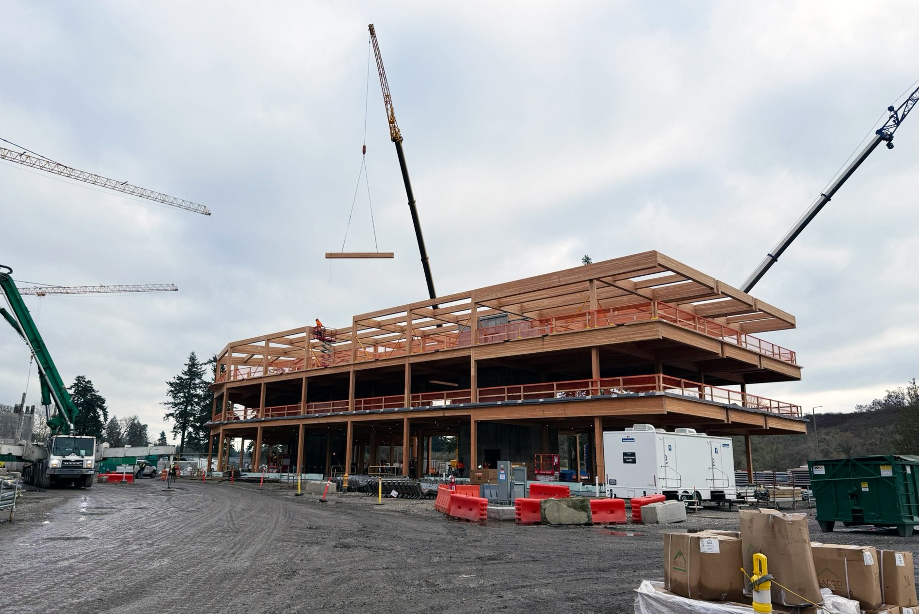 Construction photo showing the topping out of the final glulam beam to the Western State Hospital’s new administration building, designed by HOK.