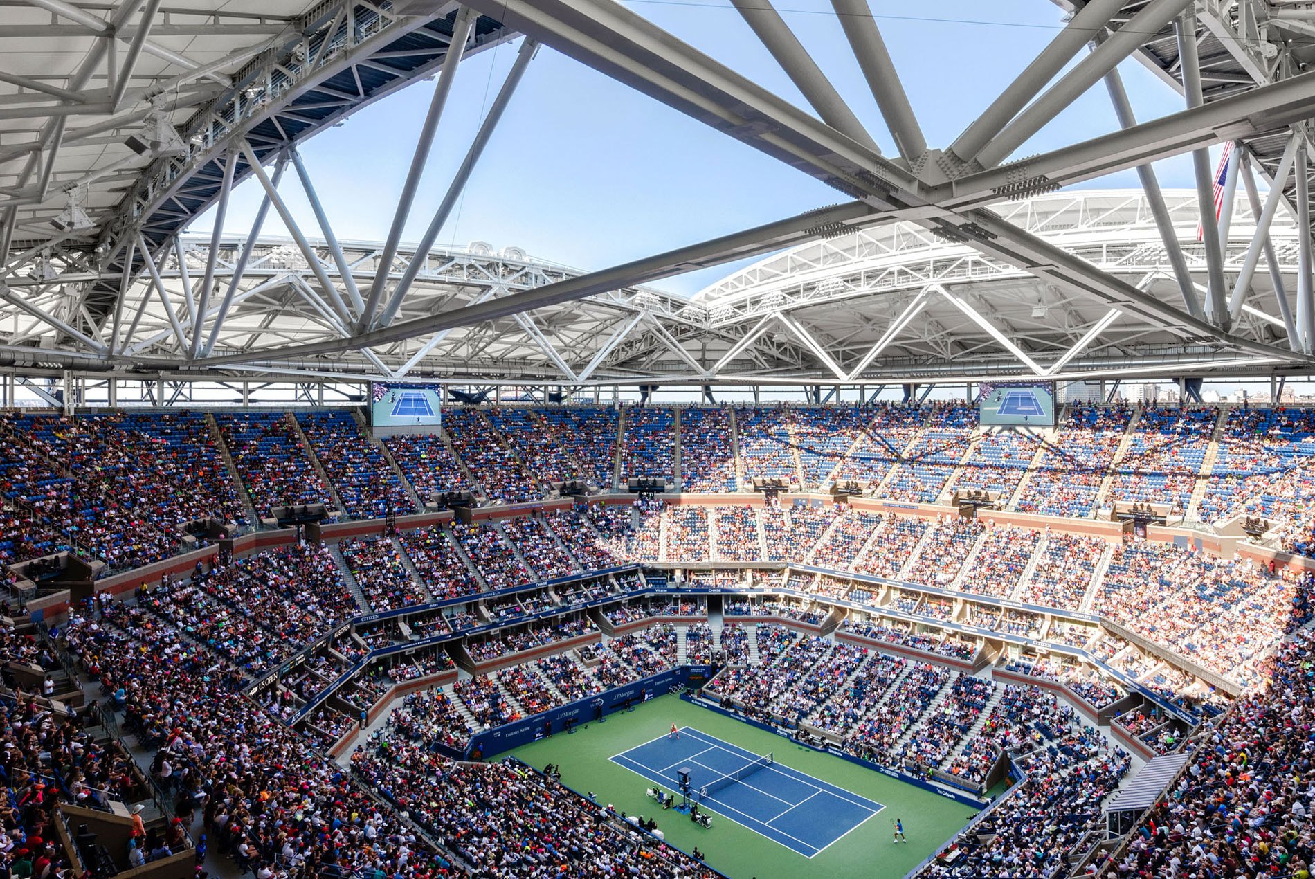 The seating bowl at the USTA Ashe Stadium with a tennis match below