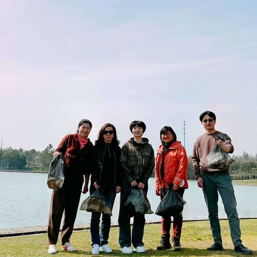 Employees volunteering at a garbage cleanup event through HOK Impact in Shanghai