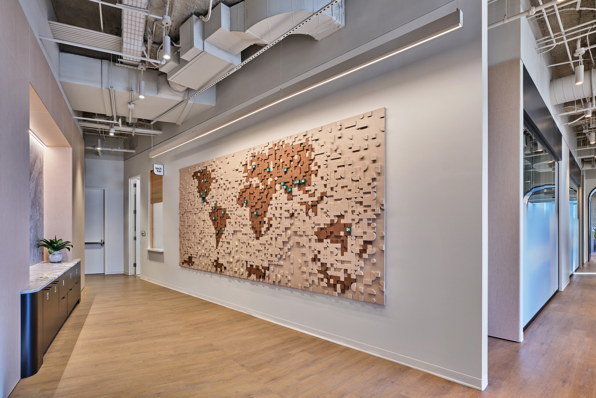 HOK-designed custom mosaic map with curved wooden pieces, with green magnetic for employees and hometowns in confidential Houston office
