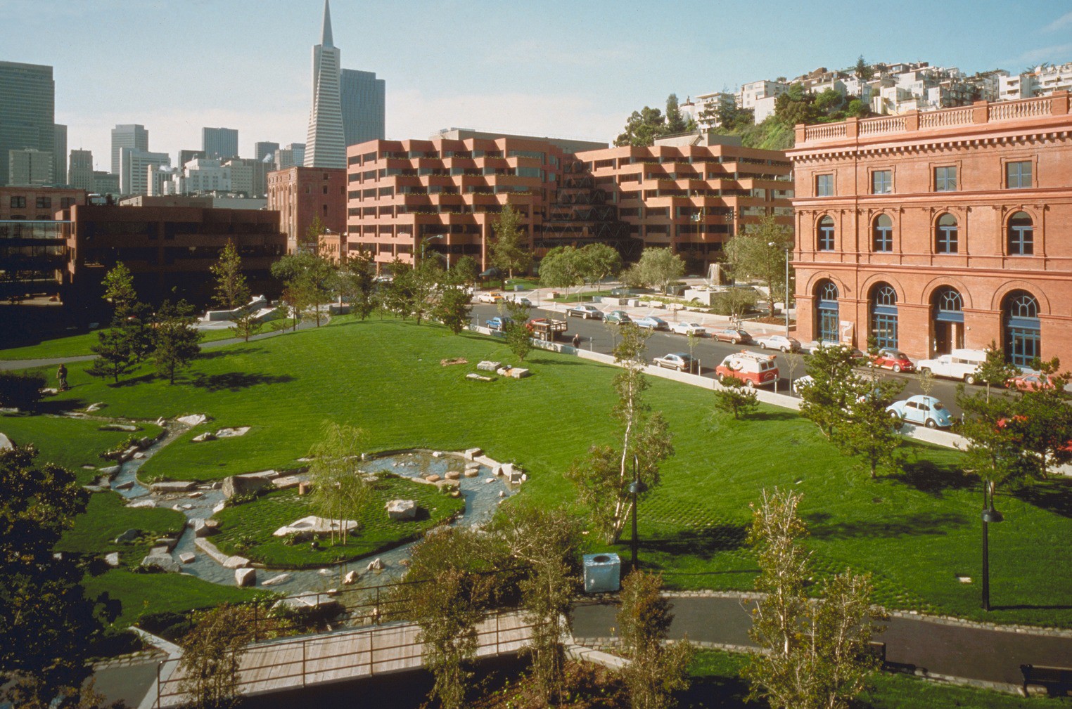 Green landscaping and pond features in front of HOK-designed Levi's Plaza campus in San Francisco.