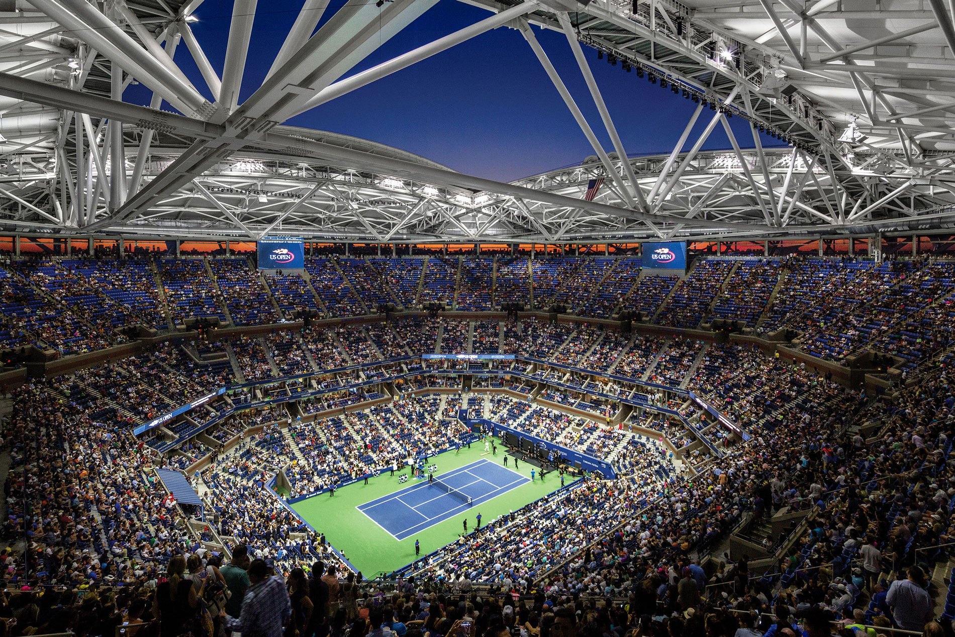 The seating bowl at the USTA Ashe Stadium with a tennis match below