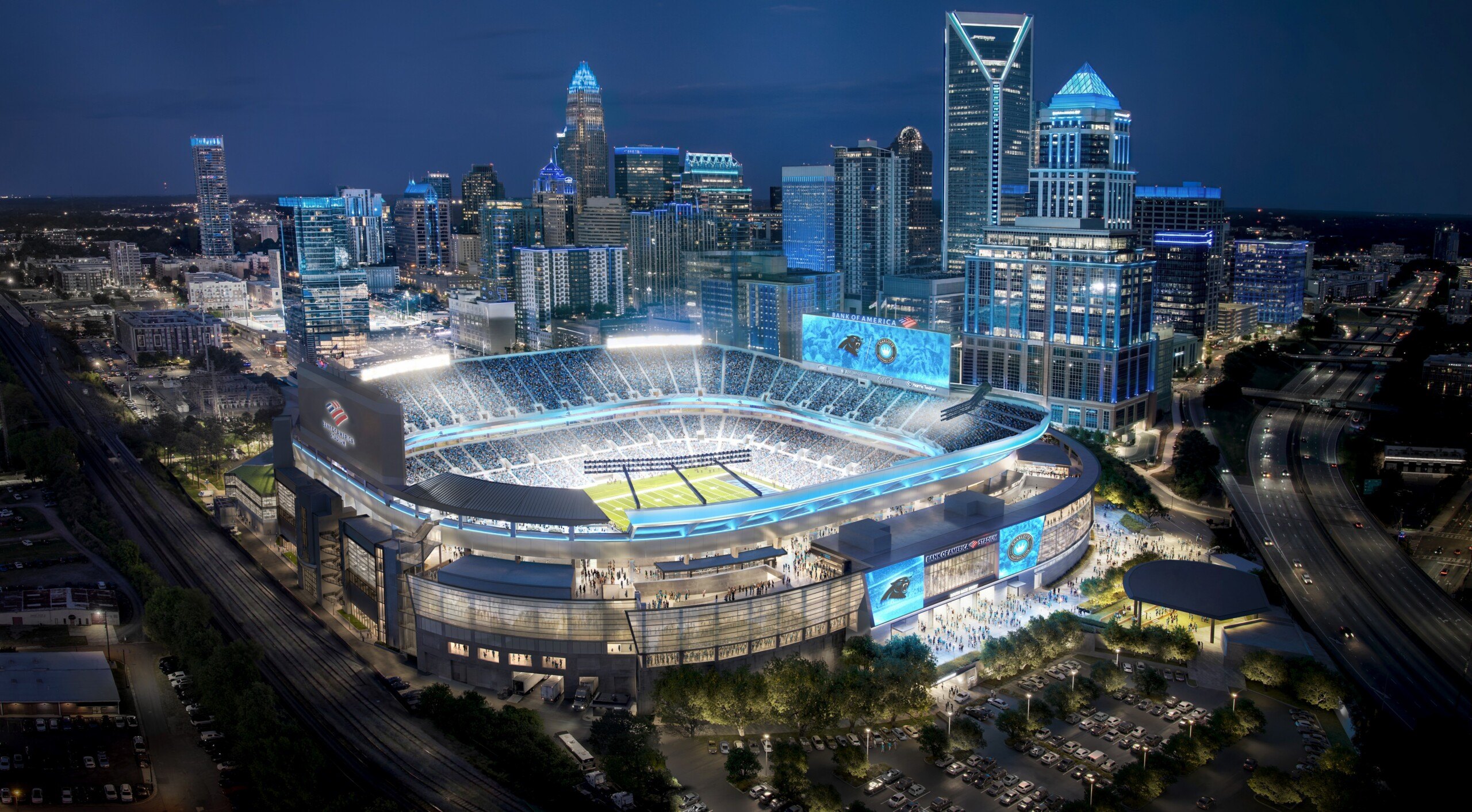 Aerial night rendering of the renovated Bank of America Stadium with its illuminated crown glowing against the Uptown Charlotte skyline