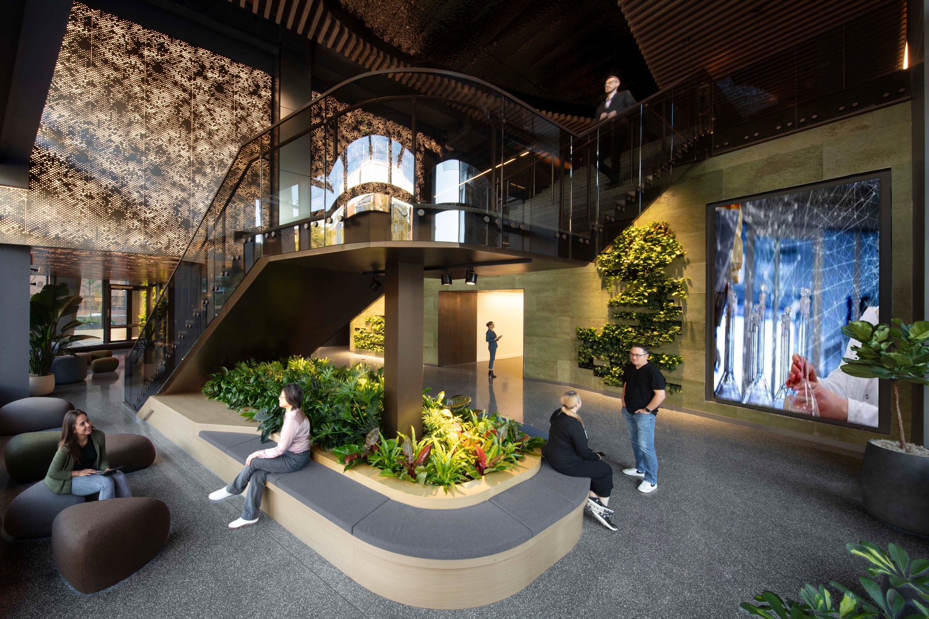 astrazeneca r&d center lobby with central stair video display and seating